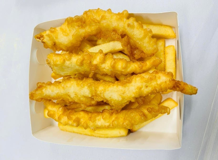Battered fish on a bed of chips